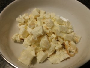 calamaro imbottito con friarielli provola e noci su polenta alla curcuma