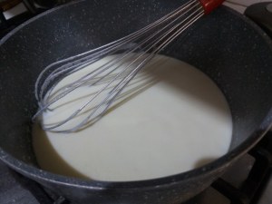 Timballo di tagliatelle con puntarelle salsiccia e crema di parmigiano allo zafferano