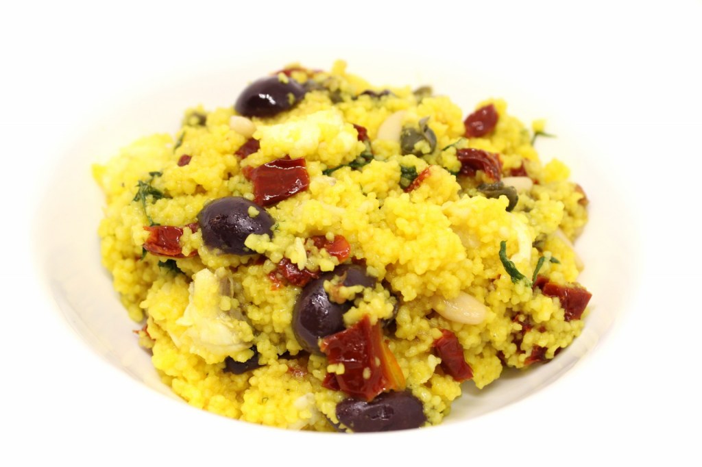 Cous cous allo zafferano con rana pescatrice pomodori secchi olive capperi pinoli e finocchietto selvatico